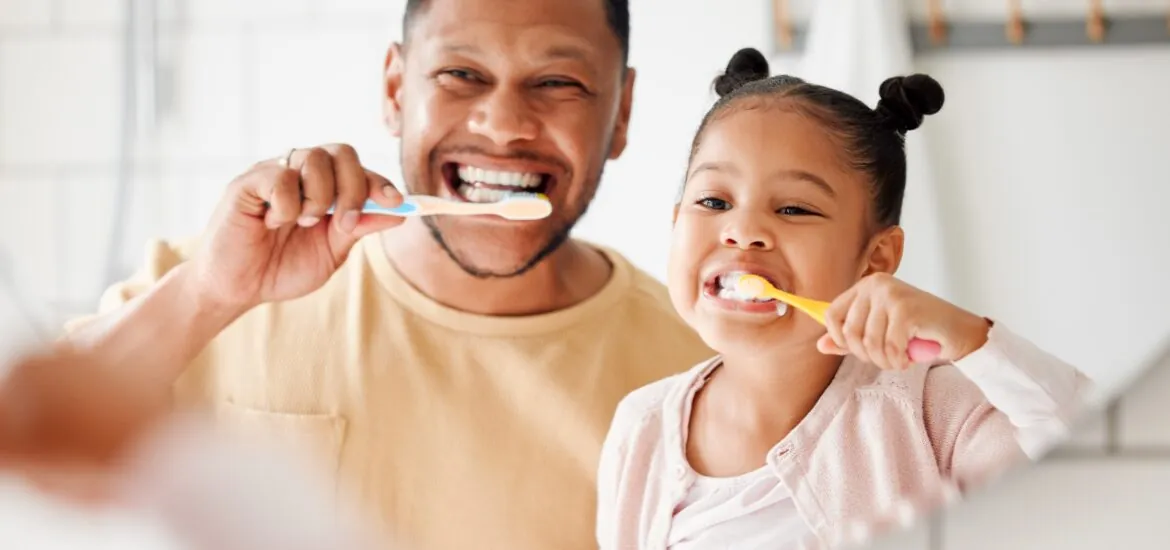 father and daughter practicing preventive dentistry in Charlotte