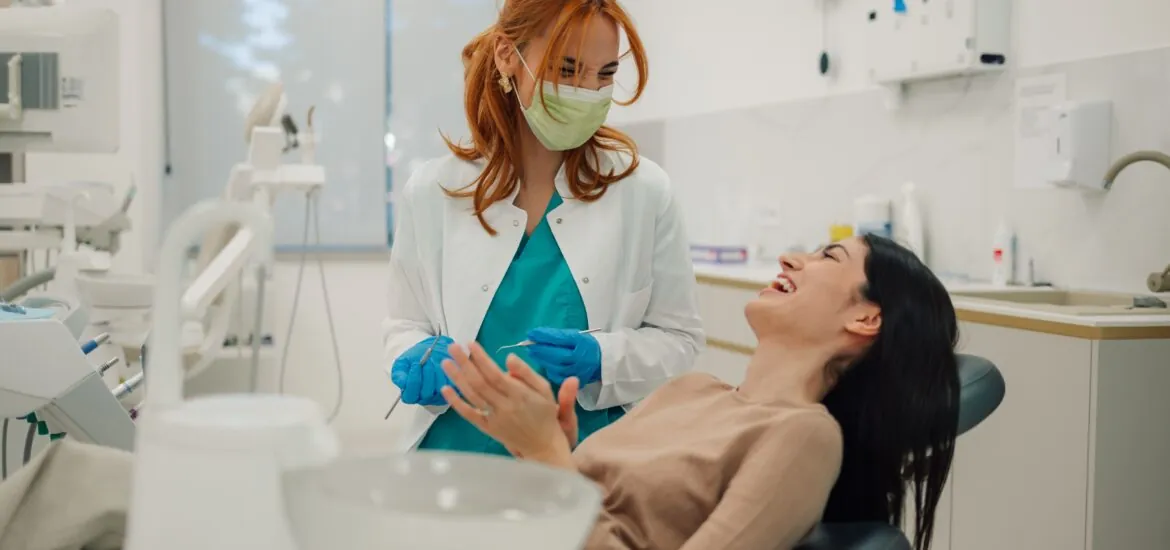 young woman laughing in a modern dental office, sedation dentistry
